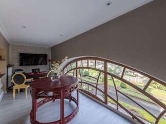 Experience unique architectural design with this stunning arched window, offering panoramic views of a lush garden landscape.