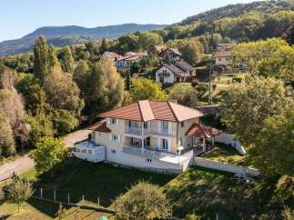 Discover this stunning multi-level home nestled on a picturesque hillside, offering breathtaking views of the surrounding mountains and lush greenery.