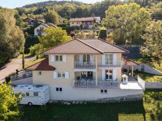Discover this charming multi-story home nestled amidst lush greenery, offering ample living space and scenic views.