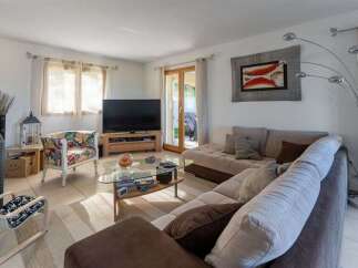 Experience modern living in this spacious living room, featuring a comfortable sectional sofa perfect for relaxation and entertainment.
