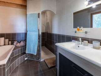 This charming bathroom features a spacious bathtub and a separate shower area, perfect for relaxation.