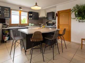 This spacious kitchen features a large island with seating, perfect for casual dining and entertaining.