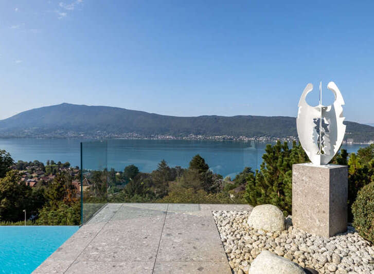 Experience luxury living with this stunning property featuring an infinity pool and breathtaking lake views.