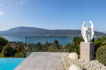 Experience luxury living with this stunning property featuring an infinity pool and breathtaking lake views.