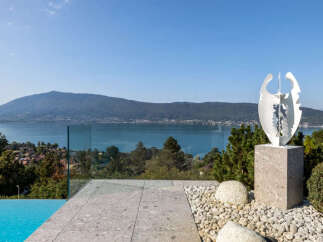 Experience luxury living with this stunning property featuring an infinity pool and breathtaking lake views.