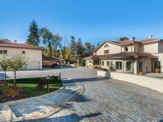 Discover this luxurious estate featuring a grand main residence and a separate guest house, both boasting elegant architecture and ample living space.