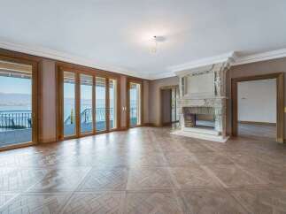 Experience luxurious living with this stunning property featuring expansive glass doors that open to breathtaking lake and mountain views.