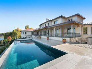 Experience luxurious living with this stunning estate featuring a large, pristine swimming pool and expansive patio perfect for entertaining.