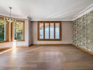 Experience breathtaking lake views from this elegant room, featuring a stunning bay window and a large picture window that floods the space with natural light.