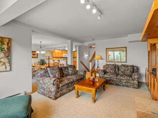 Step into this inviting living room, featuring a floral-patterned sofa and armchair perfect for relaxation.