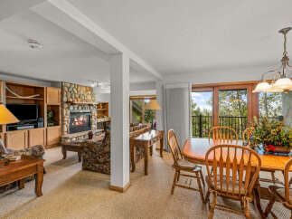 Experience cozy living in this inviting space featuring a stone fireplace and a spacious entertainment center.