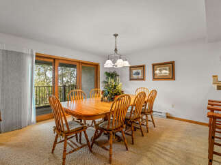 This dining room features a large wooden table with eight chairs, perfect for family gatherings.