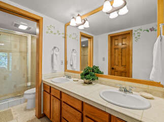 This charming bathroom features a spacious double vanity with two sinks and ample storage, perfect for busy mornings.