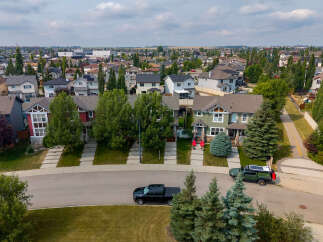 Discover this charming suburban neighborhood featuring a variety of well-maintained homes with manicured lawns and mature trees.