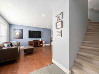 Step into this inviting living room featuring a plush brown leather sofa and ottoman, perfect for relaxation.