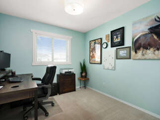 This home office features a spacious desk with a computer setup, perfect for productivity.