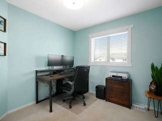This home office features a modern desk with dual monitors, perfect for productivity.