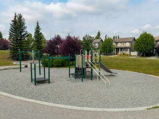 Enjoy outdoor fun in this vibrant community playground, featuring a slide, swings, and climbing structures perfect for active children.
