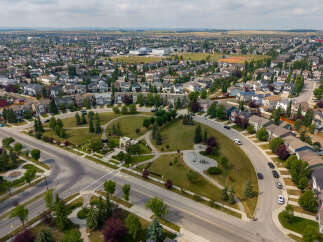 Discover this stunning aerial view of a well-maintained suburban neighborhood, showcasing a variety of modern homes with manicured lawns and mature trees.