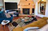 Experience cozy living in this inviting living room featuring a modern fireplace and a large flat-screen TV.