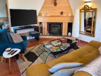 Experience cozy living in this inviting living room featuring a modern fireplace and a large flat-screen TV.