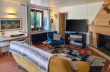Experience cozy living in this charming living room, featuring a plush yellow sofa adorned with a faux fur throw, perfect for relaxing evenings.