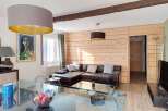 Experience cozy living in this charming apartment featuring a spacious L-shaped leather sofa perfect for relaxation.