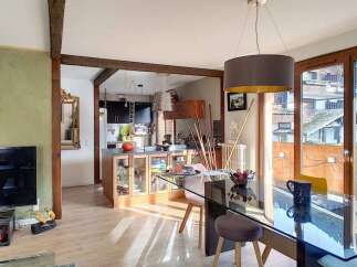 Discover this charming open-concept living space, seamlessly blending a modern kitchen with a dining area perfect for entertaining.