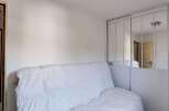 Discover this cozy room featuring a comfortable white sofa, perfect for relaxation.