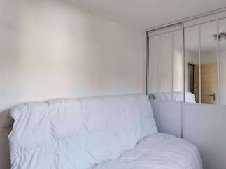 Discover this cozy room featuring a comfortable white sofa, perfect for relaxation.