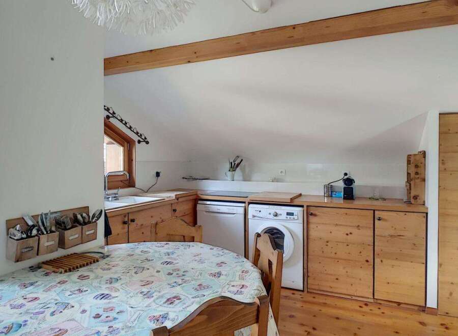 Discover this charming kitchen and dining area, perfect for cozy meals.