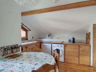 Discover this charming kitchen and dining area, perfect for cozy meals.