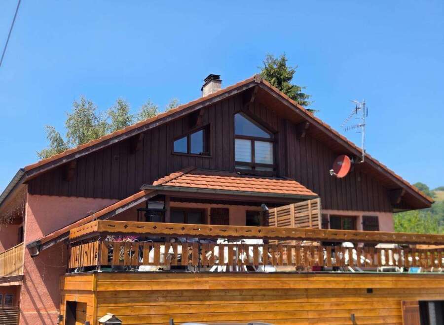 Charming wooden chalet with a spacious balcony offering scenic views.
