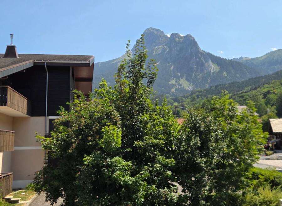 Experience breathtaking mountain views from this property, nestled amidst lush greenery.