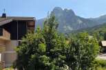 Experience breathtaking mountain views from this property, nestled amidst lush greenery.