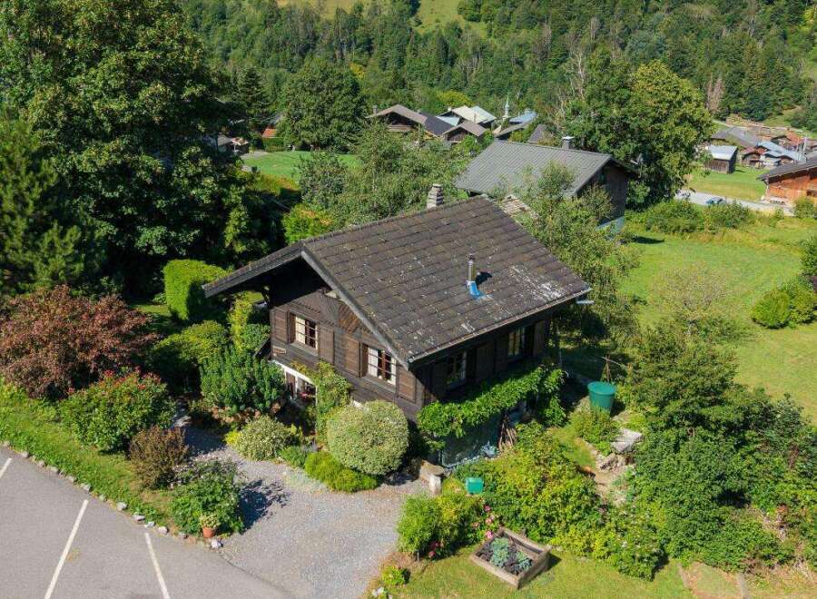 Nestled amidst lush greenery and rolling hills, this charming wooden chalet offers a serene mountain retreat.
