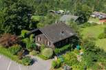 Nestled amidst lush greenery and rolling hills, this charming wooden chalet offers a serene mountain retreat.