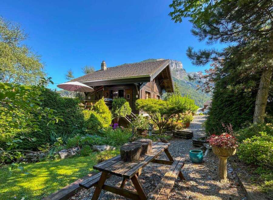 Escape to this charming wooden cabin nestled amidst lush greenery and breathtaking mountain views.