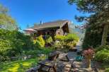 Escape to this charming wooden cabin nestled amidst lush greenery and breathtaking mountain views.