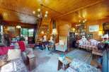 Step into this charming rustic living room, featuring warm wood-paneled walls and a cozy atmosphere.