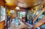 Experience rustic charm in this cozy dining area, featuring warm wood paneling throughout and a large wooden table perfect for family gatherings.