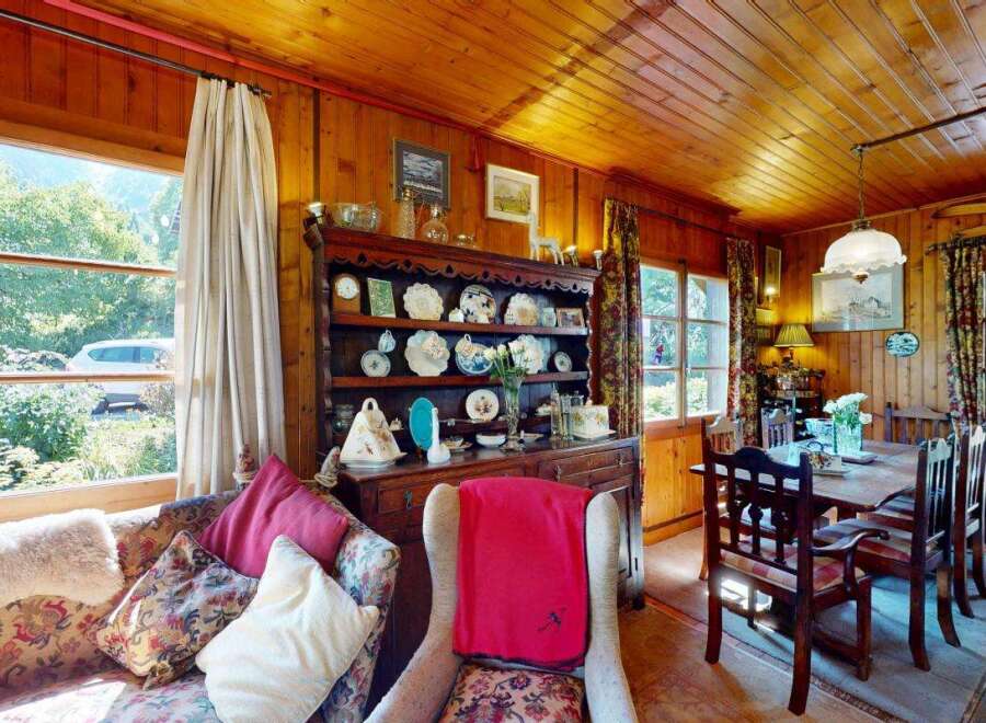 Step into a charming rustic living and dining area, perfect for cozy gatherings.