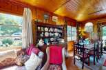 Step into a charming rustic living and dining area, perfect for cozy gatherings.