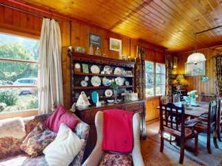 Step into a charming rustic living and dining area, perfect for cozy gatherings.