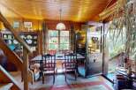 Step into a charming dining area featuring a rustic wooden table and chairs, perfect for intimate meals.