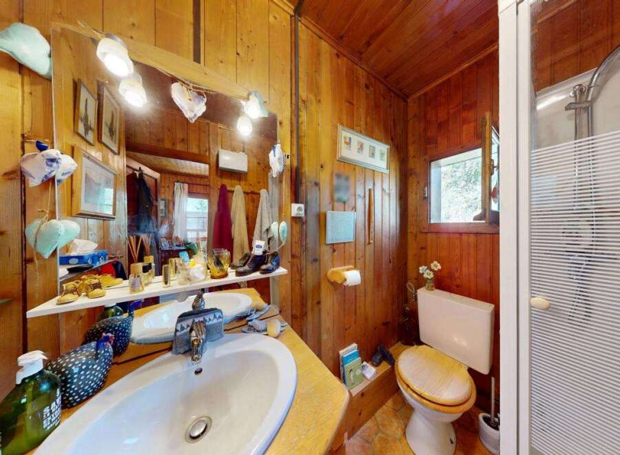 This charming bathroom features a rustic wooden interior, creating a warm and inviting atmosphere.