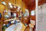 This charming bathroom features a rustic wooden interior, creating a warm and inviting atmosphere.