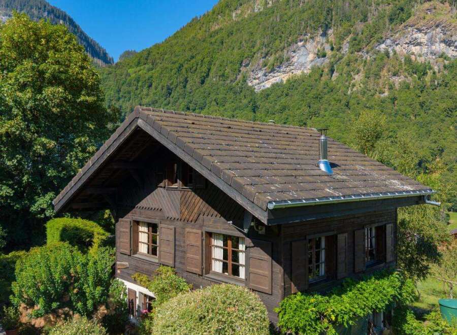 Nestled amidst lush greenery and majestic mountains, this charming wooden chalet offers a serene retreat.
