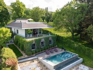 Experience modern luxury in this stunning home featuring a sleek design with expansive glass walls that seamlessly blend indoor and outdoor living.
