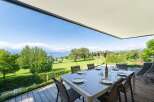 Enjoy breathtaking lake and golf course views from this stunning modern home's expansive deck.